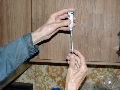 Draw insulin into syringe